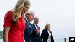 President Joe Biden and first lady Jill Biden are greeted and walk with British Prime Minister Boris Johnson and his wife Carrie Johnson, ahead of the G-7 summit, Thursday, June 10, 2021, in Carbis Bay, England. (AP Photo/Patrick Semansky)