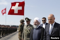 Swiss Federal President Alain Berset welcomes Iranian President Hassan Rouhani during Rouhani's official visit to Switzerland at the Zurich airport in Kloten, Switzerland, July 2, 2018.