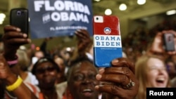 A supporter uses her personalized mobile phone to take a picture of U.S. President Barack Obama as he speaks at a campaign event at the Florida Institute of Technology in Melbourne, Florida, September 9, 2012.