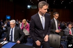 From left, Facebook general counsel Colin Stretch, Twitter acting general counsel Sean Edgett and Google information security director Richard Salgado arrive for a Senate panel's hearing on Capitol Hill in Washington, Oct. 31, 2017.