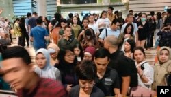 People leave a shopping mall following an earthquake in Jakarta, Indonesia, Aug. 2, 2019. A strong earthquake struck off the coast of Indonesia's Java island swaying buildings as far away as the capital. 