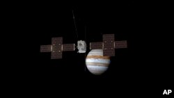 This image provided by the European Space Agency depicts the Jupiter Icy Moons Explorer, Juice, spacecraft orbiting the gas giant. (ESA/ATG Medialab via AP)
