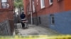 A NYC coroner carries an empty gurney at the scene of an alleged homicide in the Brooklyn borough of New York, U.S., Sept. 7, 2020. 