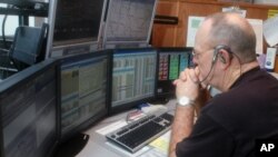 In this 2007 file photo, emergency dispatcher Larry Holmes responded to a call in Versailles, Missouri.