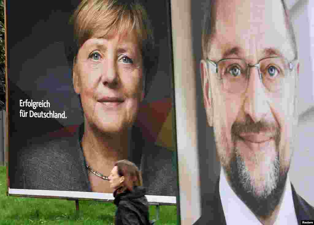 Election posters of German Chancellor Angela Merkel of the Christian Democratic Party CDU and Social Democratic Party SPD leader and top candidate Martin Schulz are seen in Hamburg, Sept. 24, 2017.