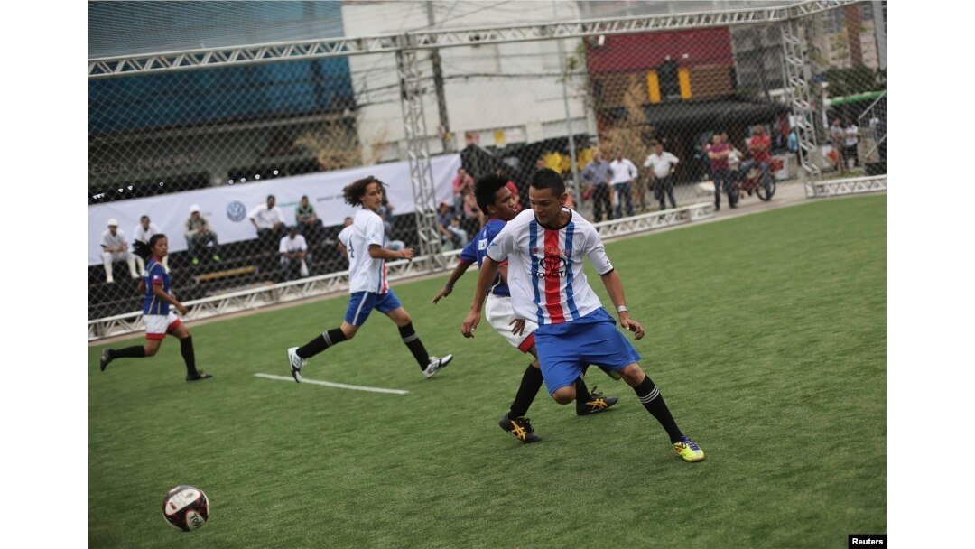 Players from Costa Rica and the Philippines (in blue shirts) compete during the "Street Soccer World Cup" in Sao Paulo, July 7, 2014.