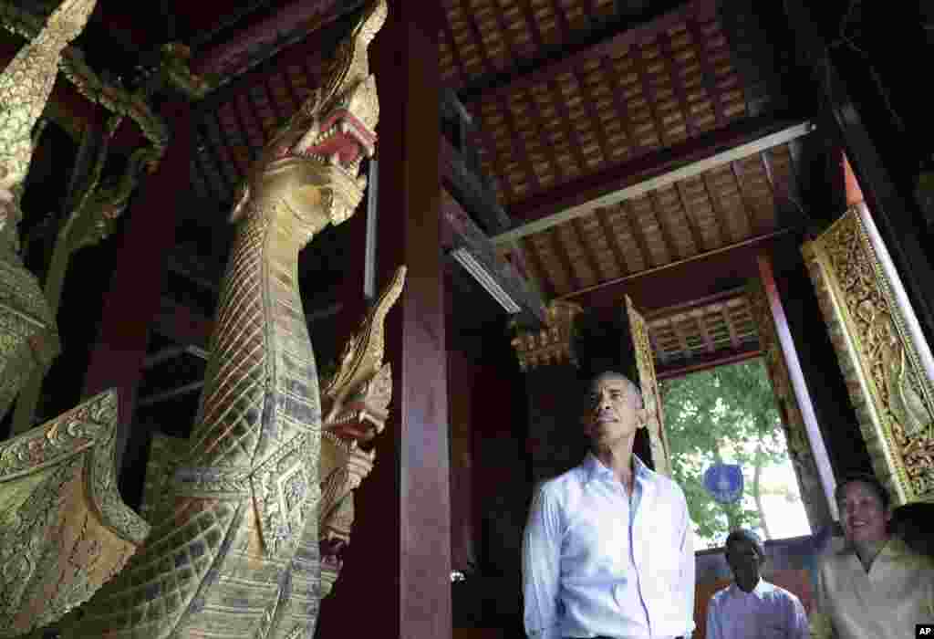 U.S. President Barack Obama pauses in the Ho Raj Rod, or Carriage House, as he tours the Wat Xieng Thong Buddhist Temple in Luang Prabang, Laos, Sept. 7, 2016.