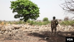 FILE - A Nigerian soldier stands amid the rubble of the Government Secondary School in Chibok, Nigeria on March 25, 2016. (Photo: Chris Stein for VOA) 