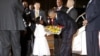 U.S. President Barack Obama receives flowers from a girl as he arrives aboard Air Force One at Jomo Kenyatta International Airport in Nairobi, July 24, 2015. 