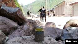 A cluster bomb shell is seen along a roadside in Noseri, near the line of control (LOC), in Neelum Valley in Kashmir August 4, 2019.