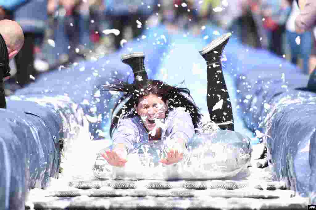 A participant takes part in the Bristol Park and Slide project, an interactive temporary installation by artist Luke Jerram set up in Park Street in the centre of Bristol, southwest England.