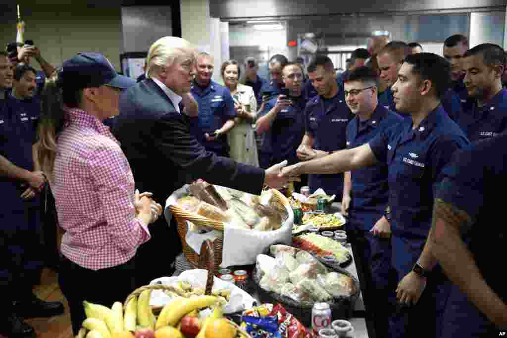 President Donald Trump, with first lady Melania Trump, greets and hands out sandwiches to members of the U.S. Coast Guard, at the Lake Worth Inlet Station, on Thanksgiving, Nov. 23, 2017, in Riviera Beach, Florida.