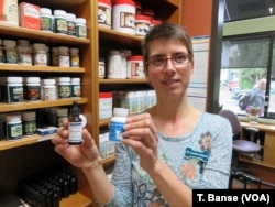 Dr. Cornelia Wagner shows several hemp-based supplements for pets stocked by the Hawthorne Veterinary Clinic.