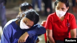 People gather outside a day care center which was the scene of a mass shooting, in the town of Uthai Sawan, around 500 km northeast of Bangkok in the province of Nong Bua Lam Phu, Thailand Oct. 6, 2022.