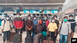 Indian workers rescued after they were lured by agents for fake job opportunities in the information technology sector in Thailand arrive at the airport in Chennai, India, Wednesday, Oct. 5, 2022. (Ministry of External Affairs via AP)