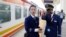 FILE - Kenya Railways attendants talk next to a train along the Standard Gauge Railway (SGR) line constructed by the China Road and Bridge Corporation (CRBC) and financed by Chinese government in Ongata Rongai, Kenya October 16, 2019.