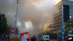 FILE - Smoke rises after a drone fired on buildings in Kyiv, Ukraine, Oct. 17, 2022.