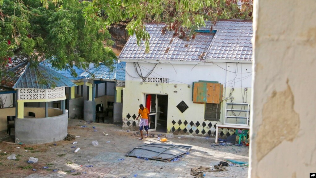 A man walks next to the damaged Tawakal hotel after it was attacked by militants in the port city of Kismayo, in southern Somalia, Oct. 24, 2022. The fatal siege marked al-Shabab's second major attack in Somalia in October.