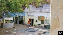 A man walks next to the damaged Tawakal hotel after it was attacked by militants in the port city of Kismayo, in southern Somalia, Oct. 24, 2022. The fatal siege marked al-Shabab's second major attack in Somalia in October.