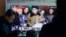 FILE - People watch a TV news program showing North Korean leader Kim Jong Un with superimposed letters that read: "North Korea has made nuclear warheads small enough to fit on ballistic missiles" at Seoul Railway Station in Seoul, South Korea, March 9, 2016. 