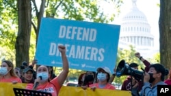 FILE - People rally outside the U.S. Capitol in Washington in support of the Deferred Action for Childhood Arrivals immigration program, Oct. 6, 2022. 