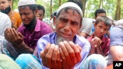 FILE - Rohingya refugees cry while praying during a gathering to mark the fifth anniversary of their exodus from Myanmar to Bangladesh, at a Kutupalong Rohingya refugee camp at Ukhiya in Cox's Bazar district, Bangladesh, Aug. 25, 2022. (AP Photo/ Shafiqur Rahman)