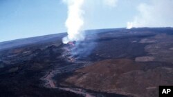 FILE - Molten rock flows from Mauna Loa on the south-central part of the island of Hawaii, April 4, 1984. Hawaii officials are warning residents of the Big Island to prepare for the possibility that the world's largest active volcano may erupt given a recent spike in earthquakes.