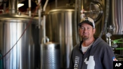 Eric Seufert, owner and manager of 105 West Brewing Co., poses for a photo at his brewery room Tuesday, Oct. 18, 2022, in Castle Rock, Colo. (AP Photo/Brittany Peterson)