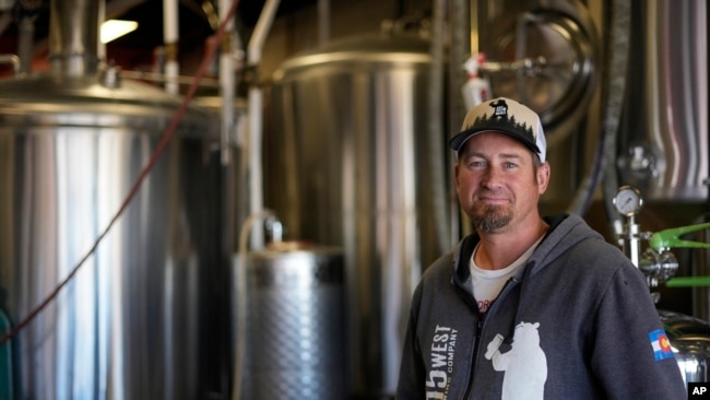 Eric Seufert, owner and manager of 105 West Brewing Co., poses for a photo at his brewery room Tuesday, Oct. 18, 2022, in Castle Rock, Colo. (AP Photo/Brittany Peterson)