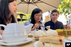 Sik Lee Dennig shares a traditional Cantonese dim sum meal with friends, family and former students in Mountain View, Calif., on Aug. 28, 2022. Dennig says she decided to retire after teaching Cantonese classes at Stanford for more than 20 years after the university cut funding to its Cantonese program. (AP Photo/Haven Daley)