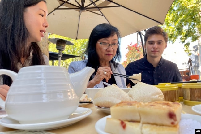 Sik Lee Dennig shares a traditional Cantonese dim sum meal with friends, family and former students in Mountain View, Calif., on Aug. 28, 2022. Dennig says she decided to retire after teaching Cantonese classes at Stanford for more than 20 years after the university cut funding to its Cantonese program. (AP Photo/Haven Daley)