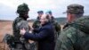 FILE - Russian President Vladimir Putin, center, speaks to a soldier as he visits a military training center of the Western Military District for mobilized reservists in Ryazan region, Russia, Oct. 20, 2022.