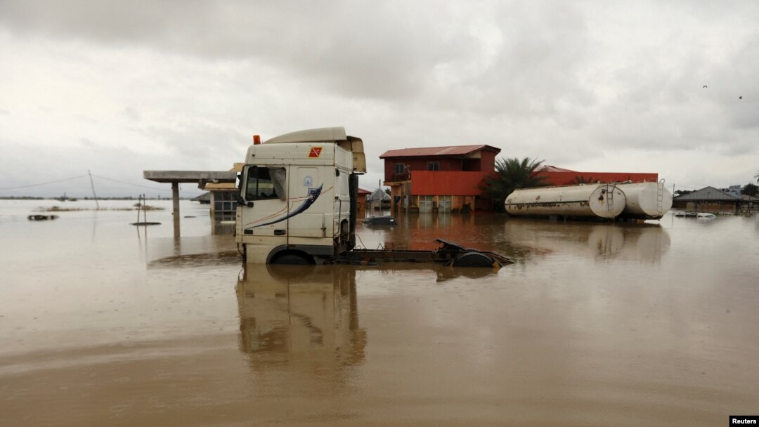 FILE - Vehicles are seen submerged in flood water at a petrol station in Lokoja, Nigeria, Oct. 13, 2022. 
