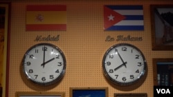 Representations of journalist Abraham Jimenez Enoa's new home in Spain and previous home in Cuba hang on a wall. (Alfonso Beato/VOA)