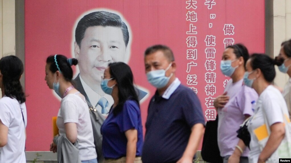 上海民众走过街头树立的一面中国领导人习近平的宣传画。（2022年8月31日）(photo:VOA)