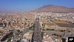 FILE - Houthi supporters attend a rally marking the seventh anniversary of the Saudi-led coalition's intervention in Yemen's war, in Sanaa, Yemen, March 26, 2022. 