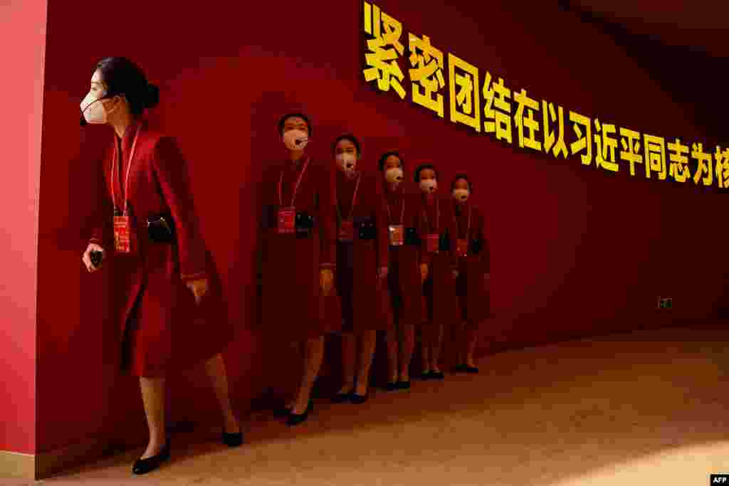 Attendants wait for visitors to the show called &quot;Forging Ahead in the New Era&quot; at the Beijing Exhibition Center in Beijing, China, ahead of the 20th Communist Party Congress meeting.
