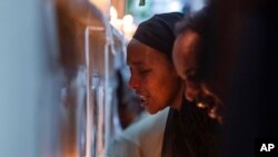 FILE - Crash victims' relatives gather at an anniversary memorial service at the Holy Trinity Cathedral in Addis Ababa, Ethiopia, March 8, 2020, to remember those killed when Ethiopian Airlines flight ET302 crashed March 10, 2019, killing all 157 on board.