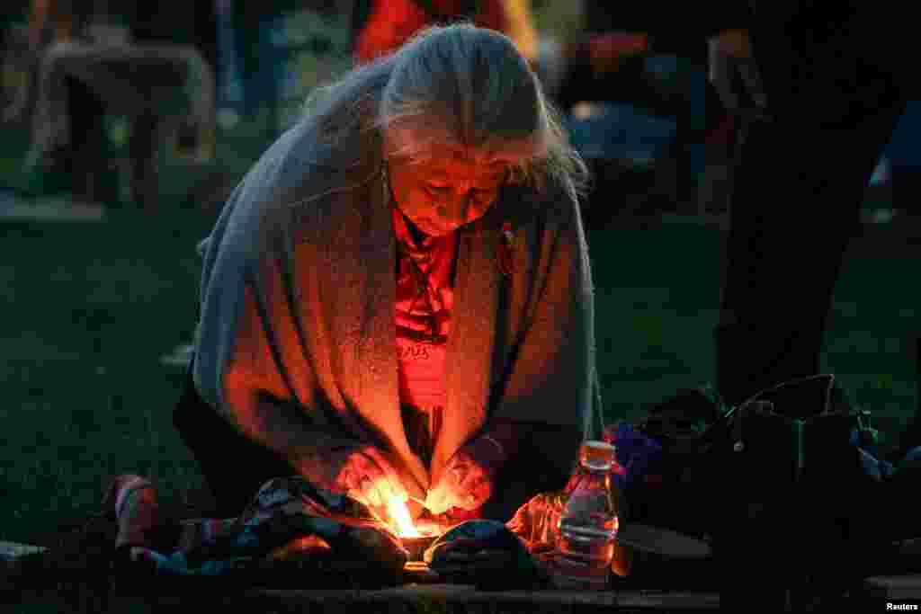 A woman prepares for sunrise ceremony, attended by Canada&#39;s Prime Minister Justin Trudeau, to mark the National Day for Truth and Reconciliation, honoring the lost children and survivors of Indigenous residential schools, at Niagara Parks power station, Ontario, Canada.