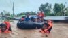 In this photo provided by the Philippine Coast Guard, rescuers use boats to evacuate residents from flooded areas due to Tropical Storm Nalgae at Parang, Maguindanao province, southern Philippines, Oct. 28, 2022. 