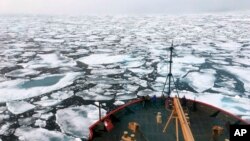FILE - This summer 2018 file photo provided by the National Oceanic and Atmospheric Administration shows the U.S. Coast Guard Icebreaker Healy on a research cruise in the Chukchi Sea of the Arctic Ocean.