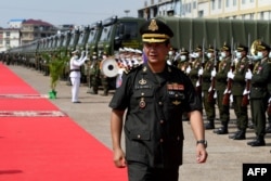 FILE - Cambodian Armed Forces deputy commander-in-chief Lt Gen Hun Manet walks past the honour guard during a ceremony to deploy 290 recently purchased Chinese military trucks to its security forces at the National Olympic stadium in Phnom Penh on June 18