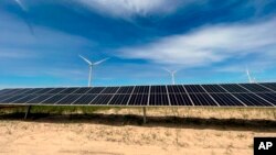 In this image provided by Portland General Electric, windmills and solar panels line a renewable energy facility in Lexington, Oregon, May 24, 2022. 