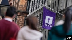 FILE - People wait in line at a COVID-19 testing site near the NYU campus in New York, Thursday, Dec. 16, 2021. (AP Photo/Seth Wenig)