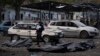 A Ukrainian police officer walks past bags containing the bodies of people who died in a Russian missile attack, in the city of Zaporizhzhia, Ukraine, Sept. 30, 2022. Russia now claims territories it holds in Ukraine's Zaporizhzhia region as its own.