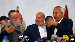 Khalil al-Hayeh, center, of Hamas, attends a press conference with Abdulaziz Minawi, left, of the Islamic Jihad group, and Talal Naji of the Popular Front for the Liberation of Palestine - General Command, right, in Damascus, Syria, Oct. 19, 2022.