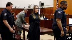 FILE — Anna Sorokin leaves after sentencing at New York State Supreme Court, in New York, May 9, 2019. 