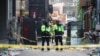 Police stand guard at the scene where a stampede during Halloween festivities killed and injured many people at the popular Itaewon district in Seoul, South Korea, Oct. 30, 2022. 