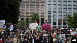 Protestors rally calling for regime change in Iran following the death of Mahsa Amini, a young woman who died after being arrested in Tehran by Iran's notorious "morality police," in Washington, Oct. 1, 2022.