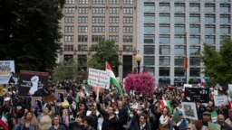 Protestors rally calling for regime change in Iran following the death of Mahsa Amini, a young woman who died after being arrested in Tehran by Iran's notorious "morality police," in Washington, Oct. 1, 2022.